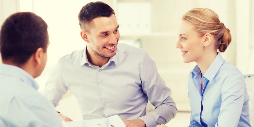 Fiduciary advisors collaborating closely with client family in executive conference room